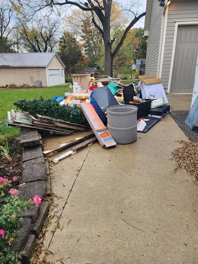 Dumpster being loaded with debris for Commercial Dumpster Rental in Montevallo